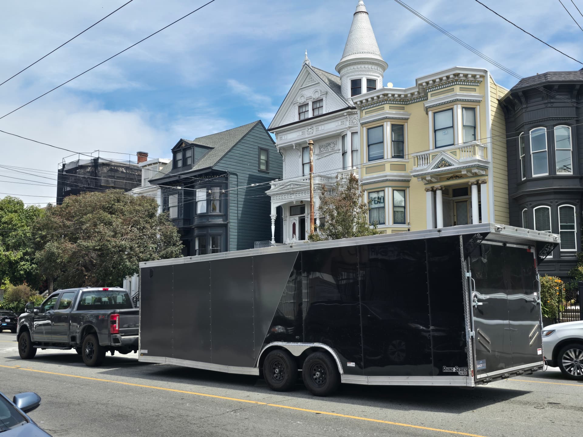 RamZ Pro Movers truck and enclosed moving trailer parked on a residential street